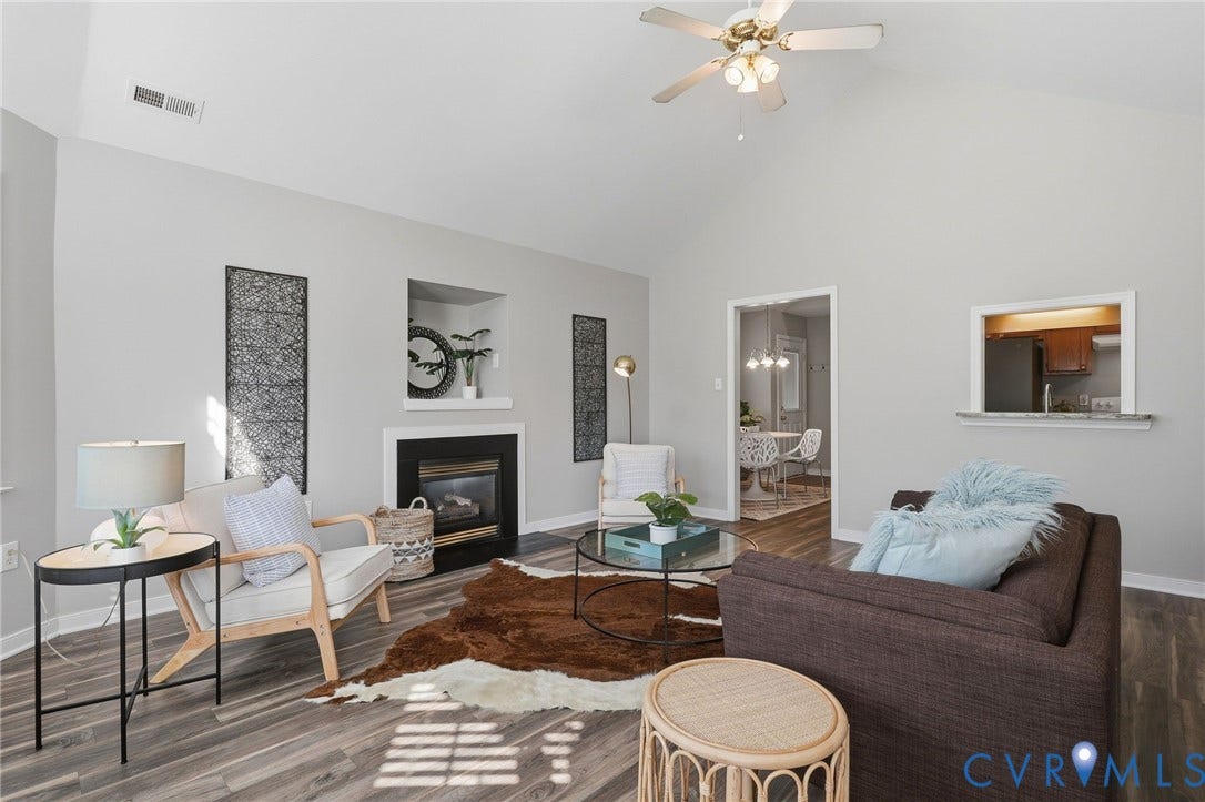932 Ayers Way, Ayers Tavern, Glen Allen, VA 23060 Vaulted ceiling with a ceiling fan, fireplace with a mantel and built-in niche, wood-finish flooring, and a pass-through window with a countertop