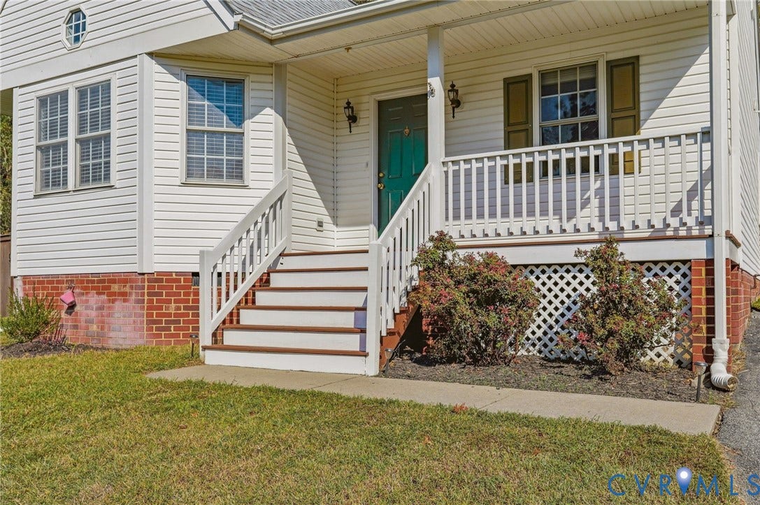 932 Ayers Way, Ayers Tavern, Glen Allen, VA 23060 Front exterior featuring white siding, a brick foundation, a covered porch with white railings, and a vibrant green front door
