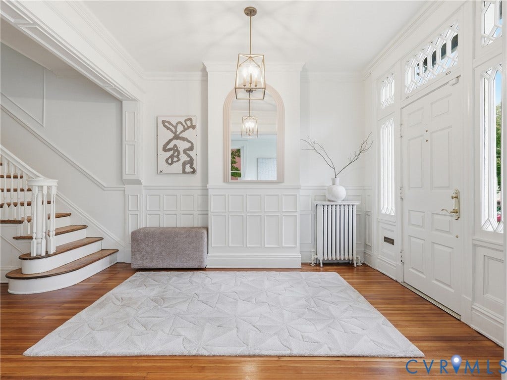 1901 Hanover Avenue, Fan, Richmond, VA 23220 Hardwood flooring, paneled walls, ornate front entry door with transom and sidelights, staircase with wood treads, and a geometric chandelier