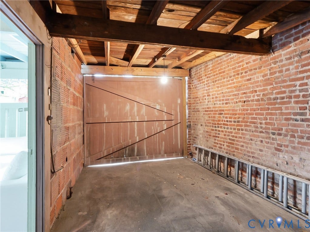 1901 Hanover Avenue, Fan, Richmond, VA 23220 Exposed brick walls, concrete flooring, and an exposed wood beam ceiling