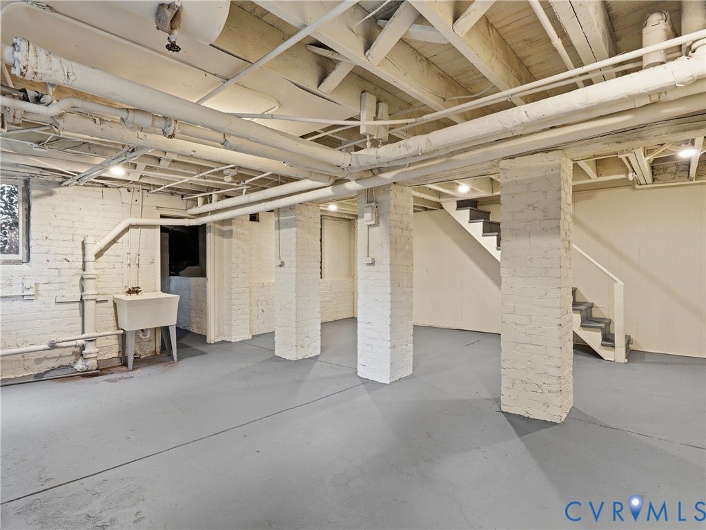1901 Hanover Avenue, Fan, Richmond, VA 23220 Painted brick walls, exposed ceiling joists, concrete flooring, utility sink, and staircase