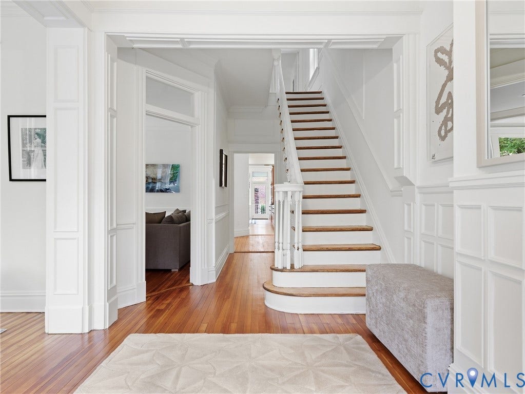 1901 Hanover Avenue, Fan, Richmond, VA 23220 Hardwood flooring throughout, white paneled walls, white trim details, and a curved staircase with white risers and wood treads