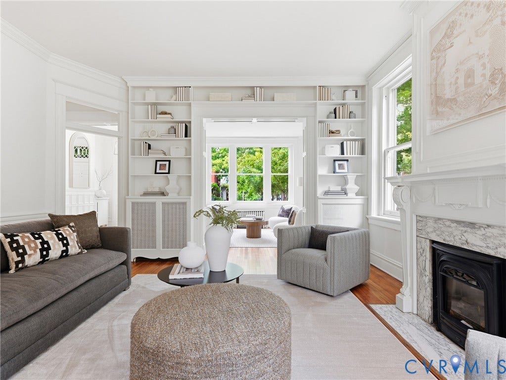 1901 Hanover Avenue, Fan, Richmond, VA 23220 Hardwood flooring, built-in shelving, decorative fireplace with a stone surround, white trim, and crown molding