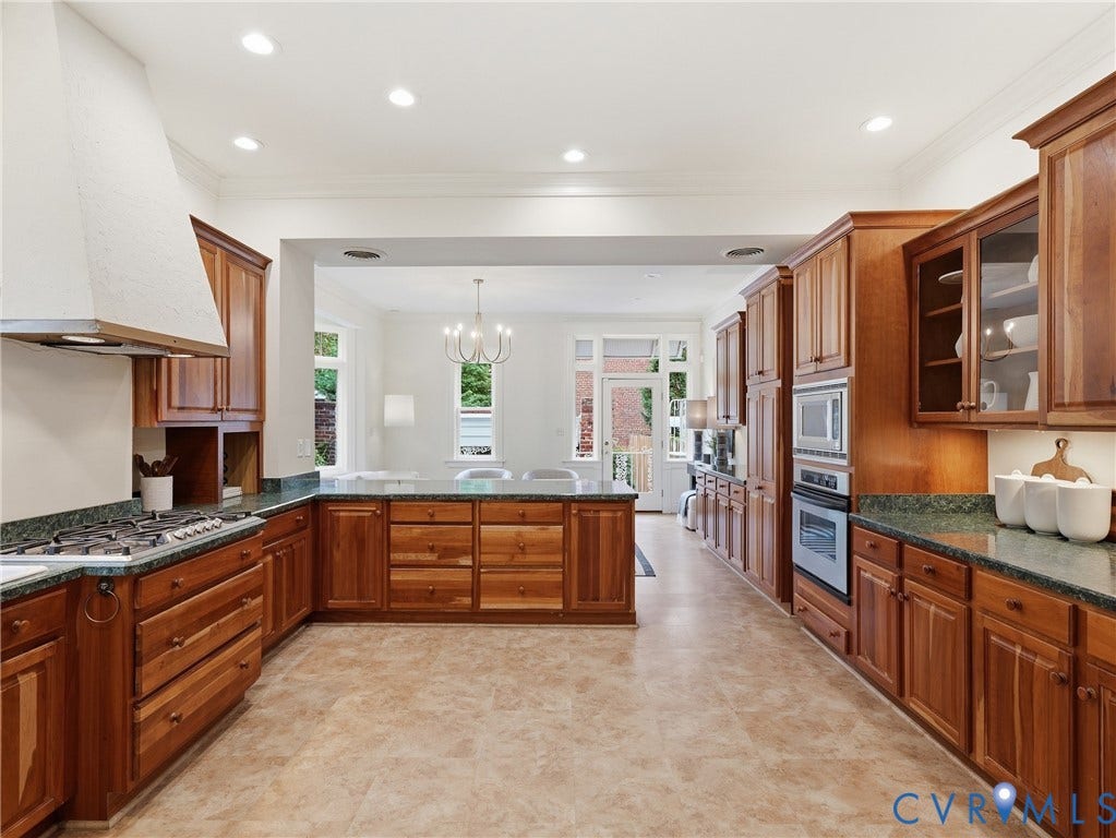 1901 Hanover Avenue, Fan, Richmond, VA 23220 Expansive kitchen featuring wood cabinetry, integrated stainless steel appliances, a gas cooktop with a range hood, and resilient flooring
