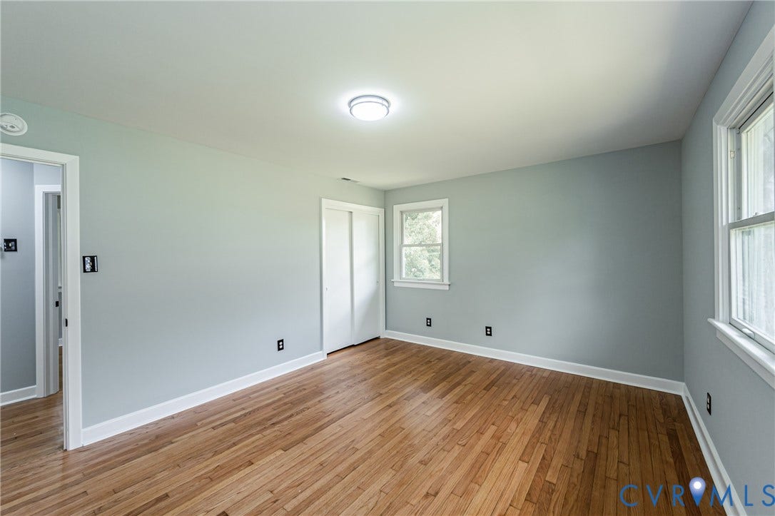 1724 Alaska Drive, Richmond, VA 23224 Hardwood flooring, painted walls, white trim, sliding closet doors, and windows