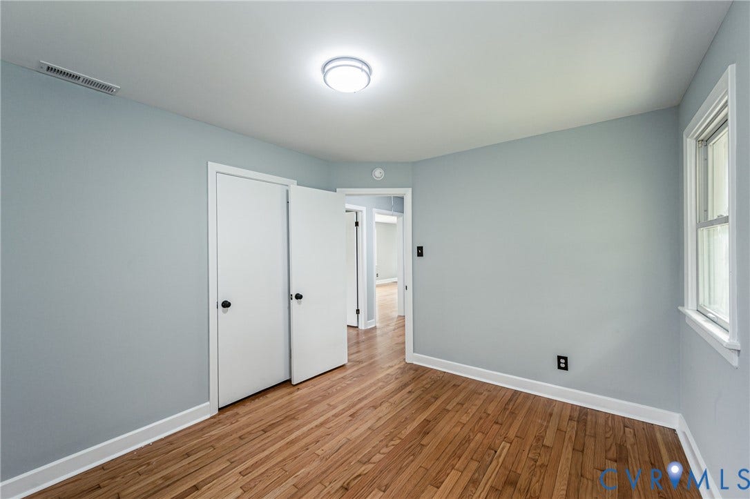 1724 Alaska Drive, Richmond, VA 23224 Hardwood flooring, painted walls, white trim, flush mount ceiling light, and a double-door closet