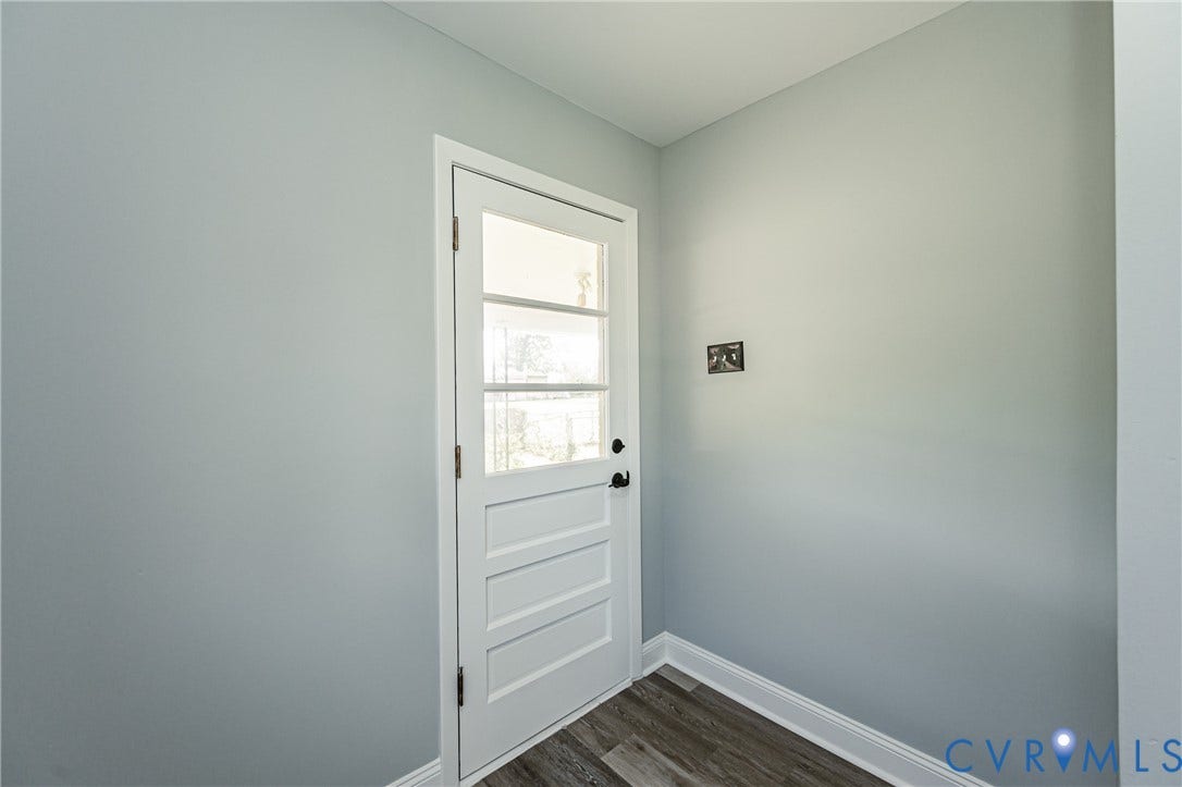 1724 Alaska Drive, Richmond, VA 23224 White paneled door with clear glass inserts, modern black hardware, and wood-finish flooring