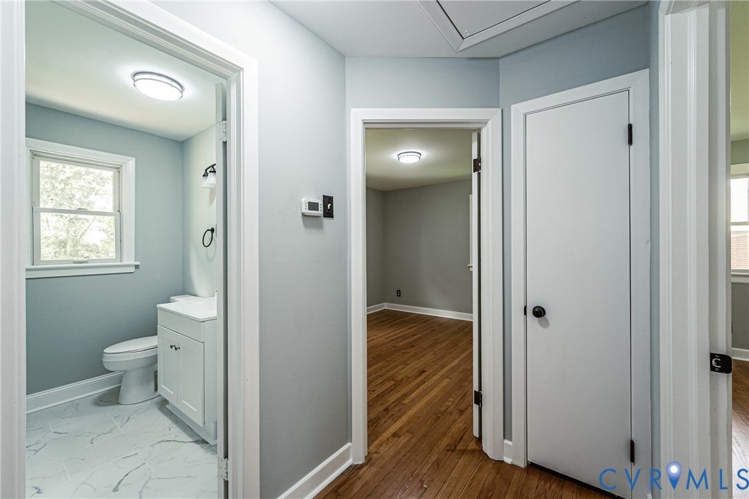 1724 Alaska Drive, Richmond, VA 23224 Bathroom featuring a white vanity with integrated sink, toilet, and white-framed window