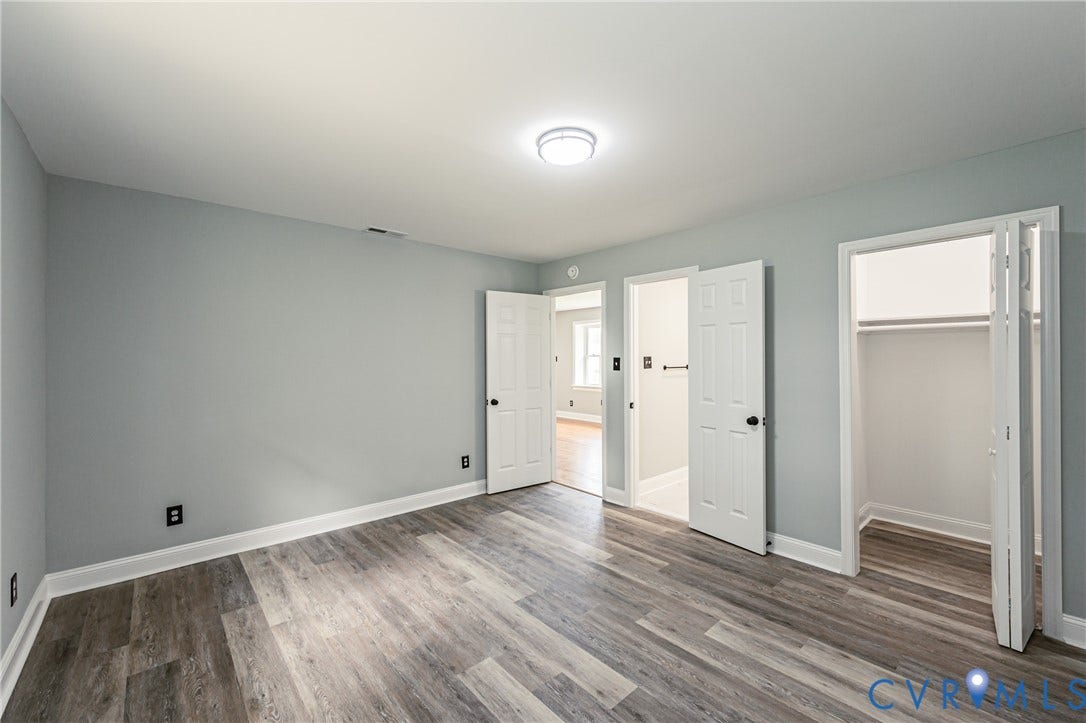 1724 Alaska Drive, Richmond, VA 23224 Wood-finish flooring, light gray wall paint, and a flush mount ceiling light