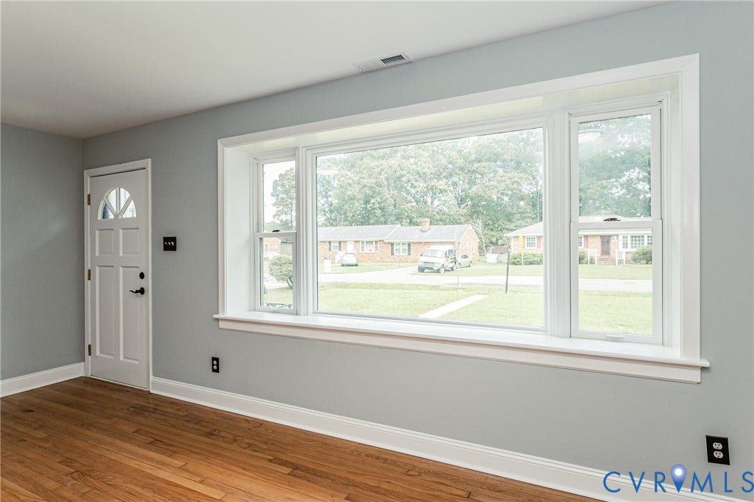1724 Alaska Drive, Richmond, VA 23224 Wood-finish flooring, light gray wall paint, and white trim throughout