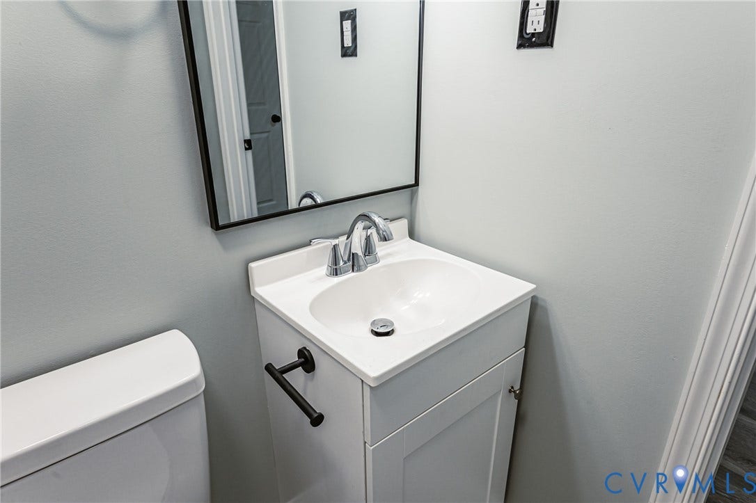 1724 Alaska Drive, Richmond, VA 23224 White vanity with an integrated sink and chrome faucet