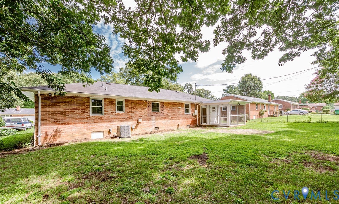 1724 Alaska Drive, Richmond, VA 23224 Brick exterior featuring a screened porch and a spacious grass yard
