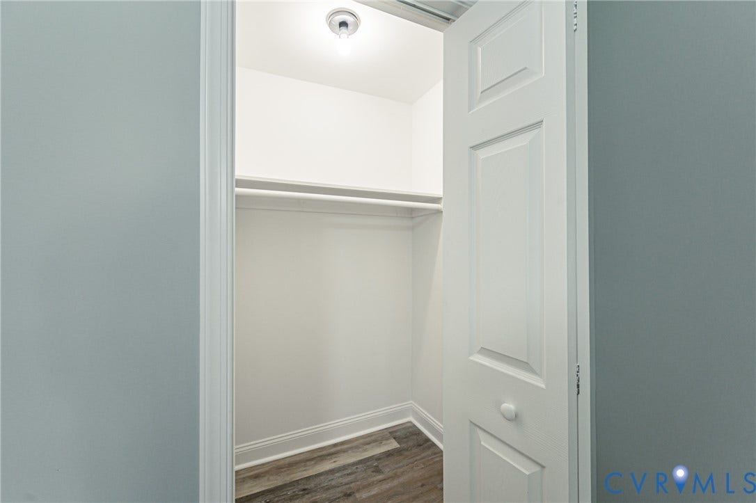 1724 Alaska Drive, Richmond, VA 23224 Closet with wood-finish flooring, integrated hanging rod, and ceiling-mounted light fixture