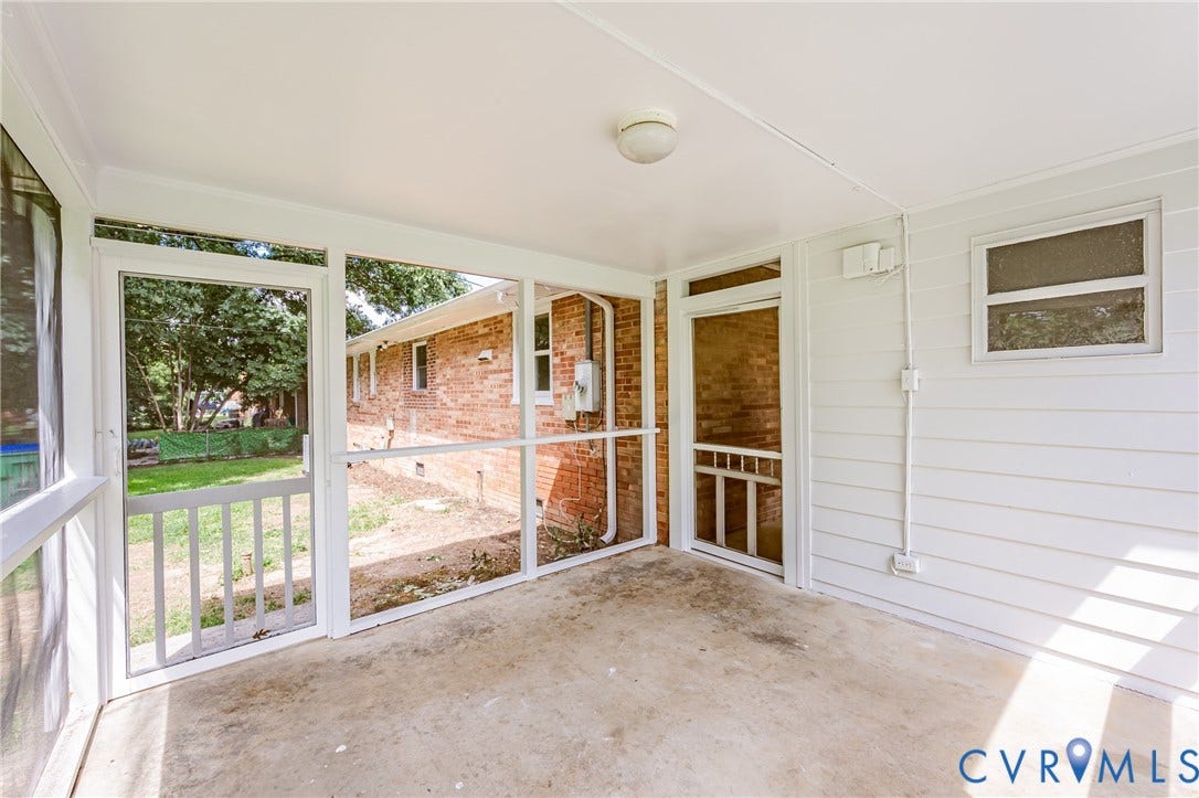 1724 Alaska Drive, Richmond, VA 23224 Screened porch featuring a concrete floor, white paneling, and a white ceiling with a flush-mount light fixture