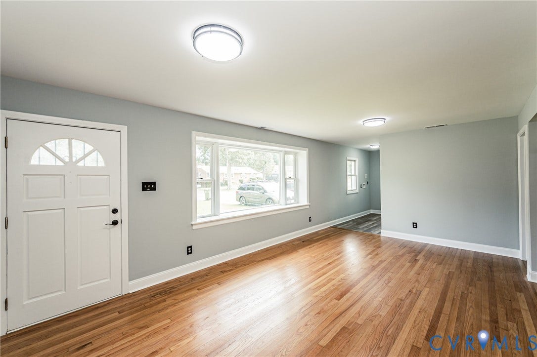 1724 Alaska Drive, Richmond, VA 23224 Hardwood flooring throughout, neutral wall paint, white trim, and a prominent front entry door with decorative glass
