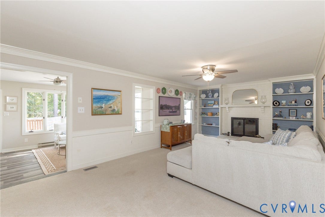 2120 Willowick Lane, Henrico, VA 23238 Built-in shelving, fireplace, ceiling fan, wainscoting, and crown molding