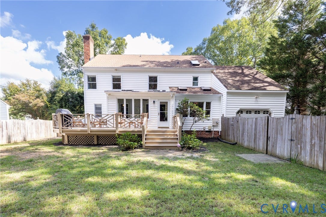 2120 Willowick Lane, Henrico, VA 23238 Expansive backyard featuring a multi-level wooden deck, a second-story dormer, and a ground-level patio door