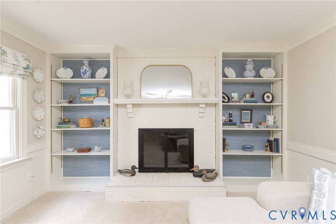 2120 Willowick Lane, Henrico, VA 23238 Built-in shelving units flank a white brick fireplace with a black firebox