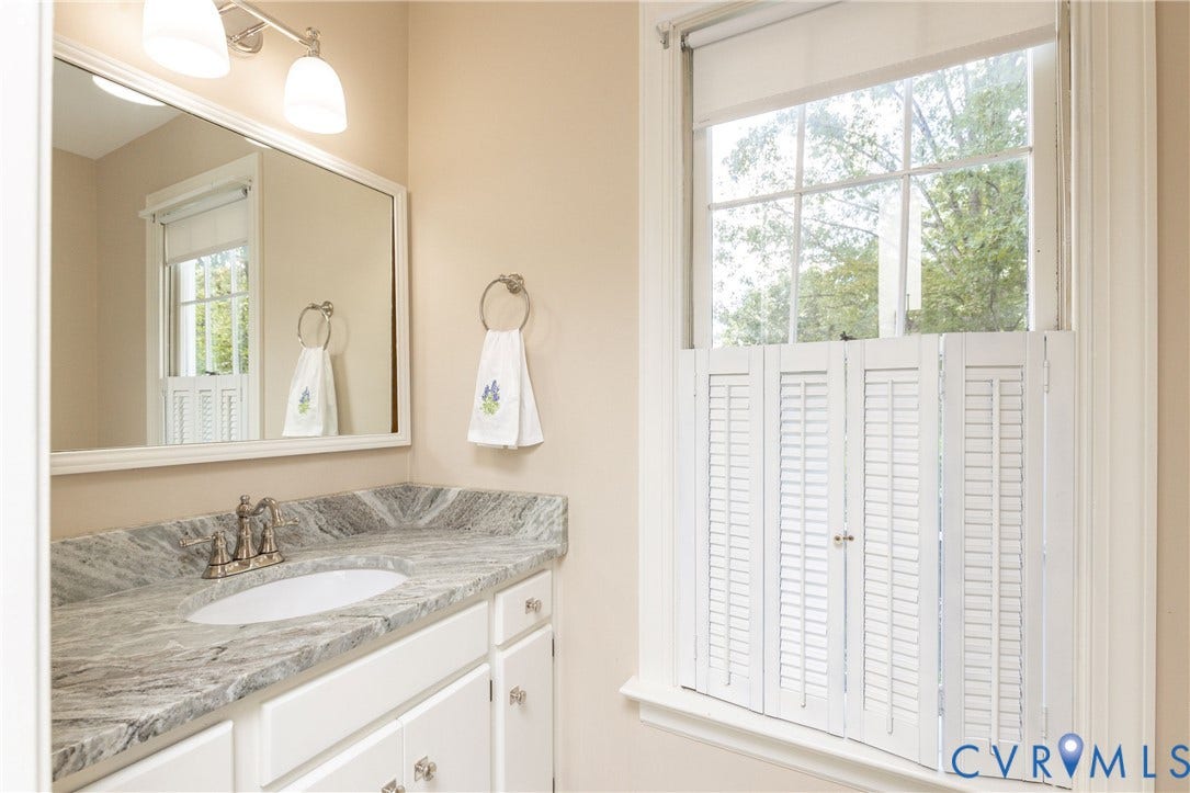 2120 Willowick Lane, Henrico, VA 23238 Bathroom featuring a vanity with a patterned countertop, a built-in sink, and a framed mirror