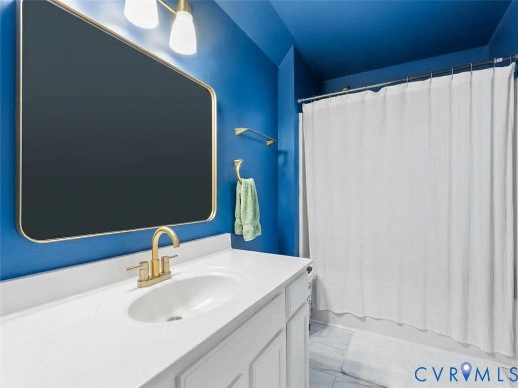 6507 Fairpines Road, North Chesterfield, VA 23234 White vanity with panel detailing, integrated sink, and brass-finish faucet