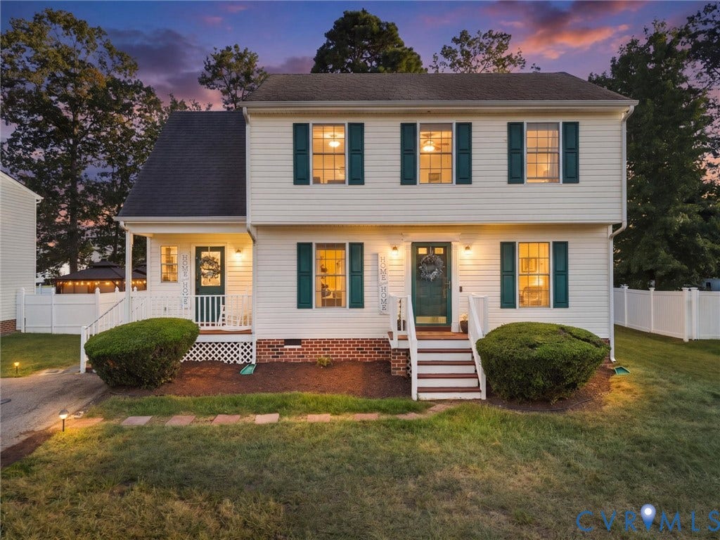 6507 Fairpines Road, North Chesterfield, VA 23234 White siding exterior with dark green shutters, brick foundation, and a covered front porch