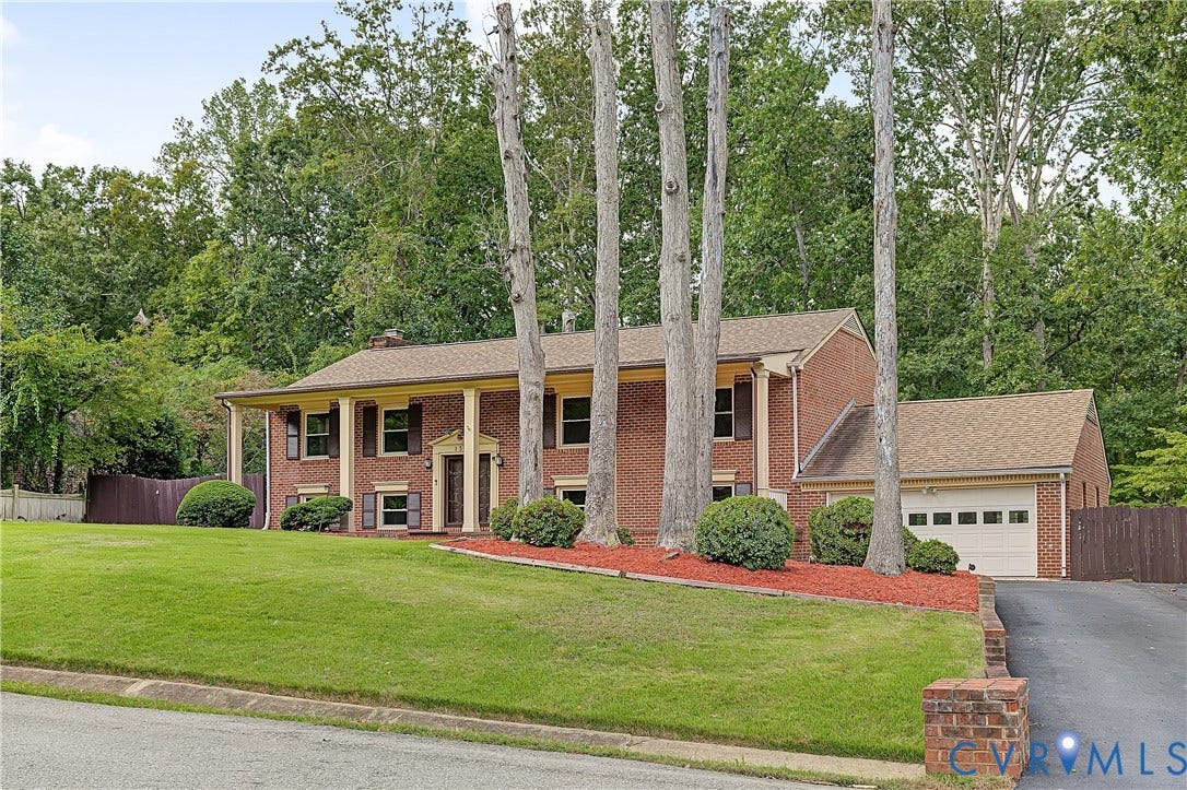 13310 Gladehill Road, Hidden Valley Estates, Chesterfield, VA 23831 Brick exterior with a covered front porch, an attached garage, and mature trees