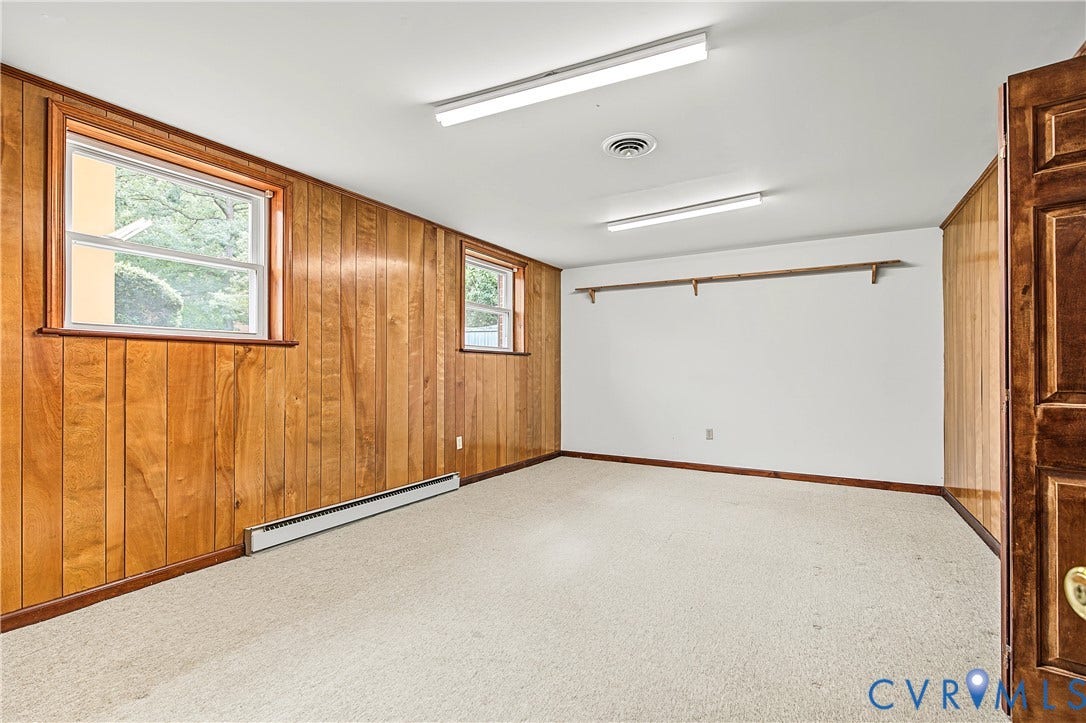 13310 Gladehill Road, Hidden Valley Estates, Chesterfield, VA 23831 Wood paneling and white painted walls, two windows, wall-to-wall carpeting, and overhead strip lighting
