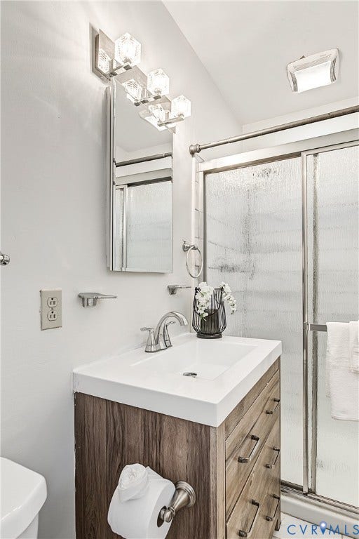 13310 Gladehill Road, Hidden Valley Estates, Chesterfield, VA 23831 Wood-finish vanity with an integrated sink, brushed nickel faucet, and a wall-mounted mirror