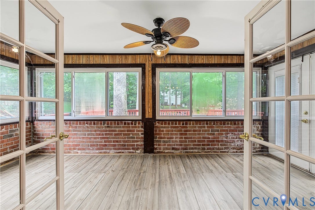 13310 Gladehill Road, Hidden Valley Estates, Chesterfield, VA 23831 Sunroom featuring light wood-finish flooring, exposed brick walls, and wood-paneled accents