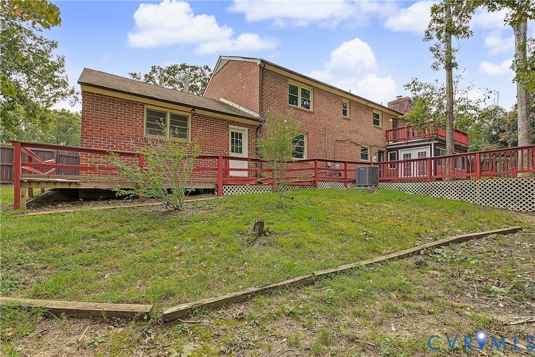 13310 Gladehill Road, Hidden Valley Estates, Chesterfield, VA 23831 Brick exterior, multiple windows, multi-level wooden deck with red railings, white lattice skirting, and mature trees