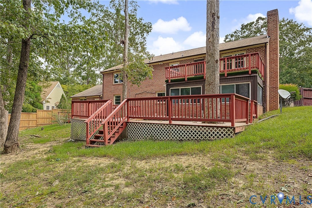 13310 Gladehill Road, Hidden Valley Estates, Chesterfield, VA 23831 Brick exterior with multiple wood decks, lattice skirting, and a full-height chimney