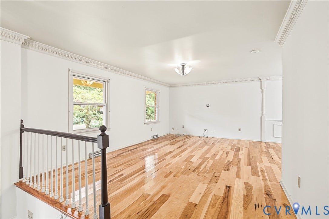 13310 Gladehill Road, Hidden Valley Estates, Chesterfield, VA 23831 Hardwood flooring, white painted walls, decorative crown molding, staircase with dark wood newel posts, and two windows