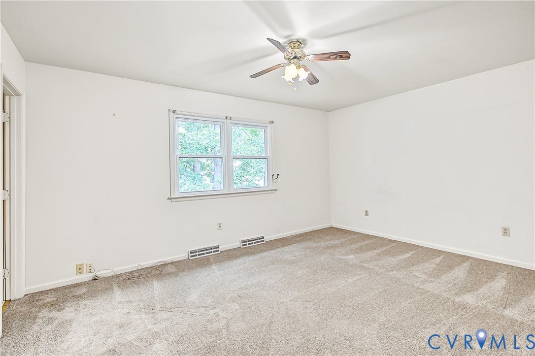 13310 Gladehill Road, Hidden Valley Estates, Chesterfield, VA 23831 Expansive room featuring neutral-toned carpeting, a window providing natural light, and a ceiling fan with integrated lighting