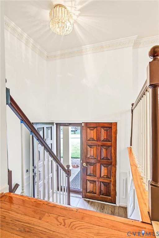 13310 Gladehill Road, Hidden Valley Estates, Chesterfield, VA 23831 Two-story foyer with a decorative chandelier, crown molding, wood-finish flooring, and a paneled wood entry door