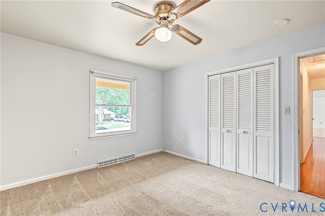 13310 Gladehill Road, Hidden Valley Estates, Chesterfield, VA 23831 Neutral wall color, carpet flooring, a window with exterior visibility, a ceiling fan with integrated lighting, and louvered bifold closet doors