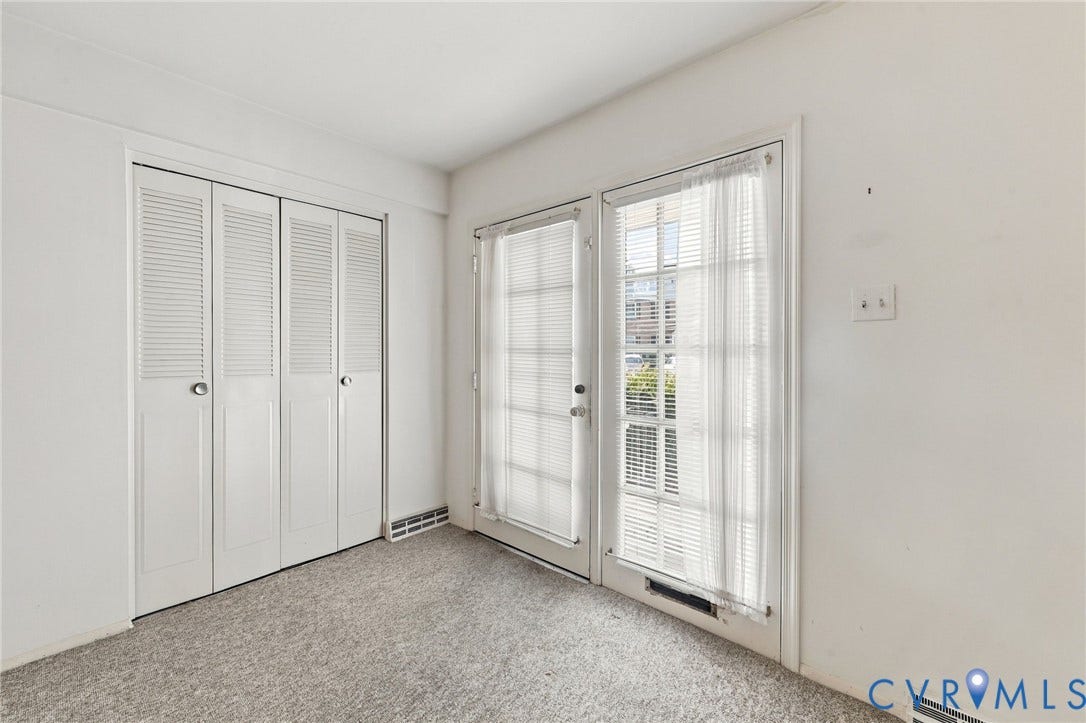 12 Snughaven Road, Hamlet, Henrico, VA 23228 White louvered bi-fold closet doors, wall-to-wall carpeting, and French doors with privacy blinds