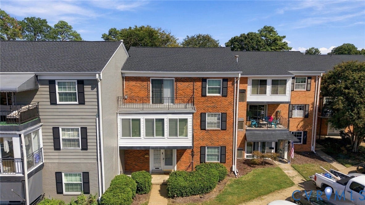 12 Snughaven Road, Hamlet, Henrico, VA 23228 Brick exterior with black shutters and a covered entry