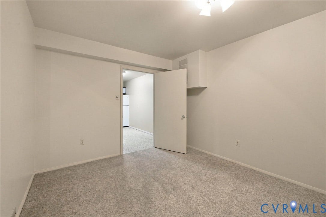 12 Snughaven Road, Hamlet, Henrico, VA 23228 Carpeted room with white painted walls and a ceiling-mounted light fixture