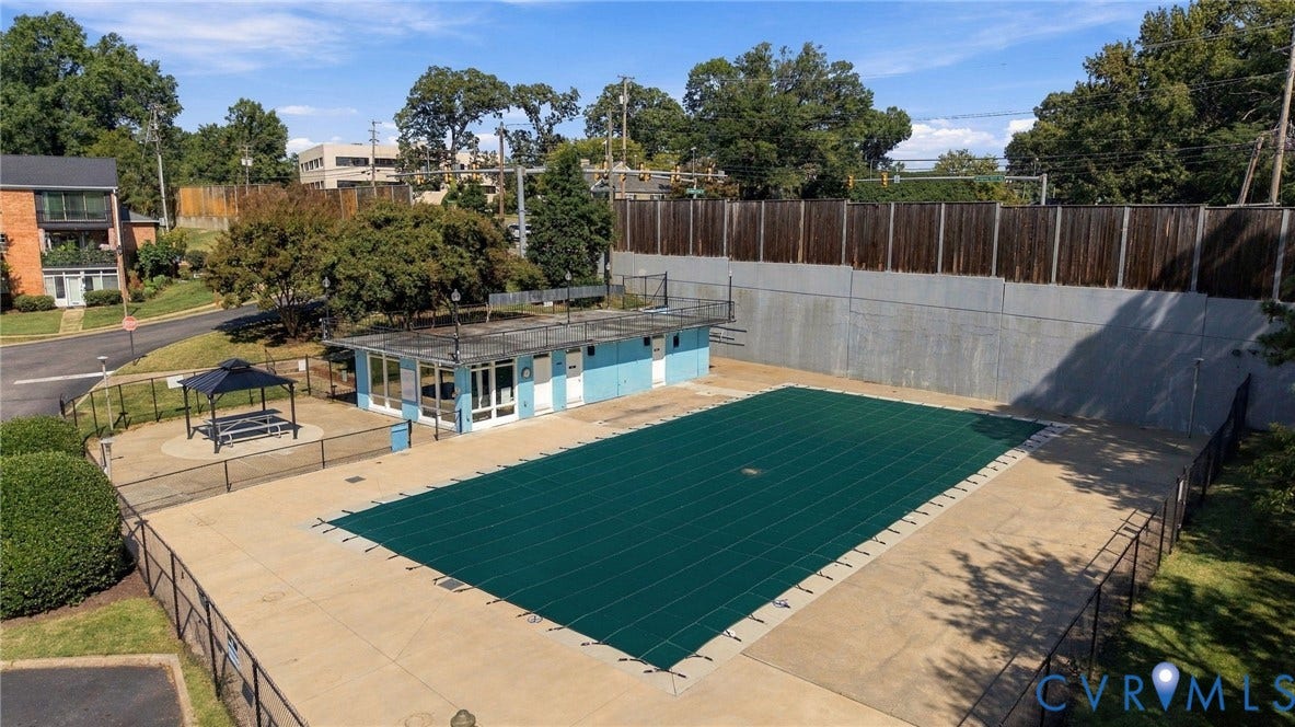12 Snughaven Road, Hamlet, Henrico, VA 23228 Outdoor swimming pool with a protective cover, surrounding paved deck, and a shaded pergola area