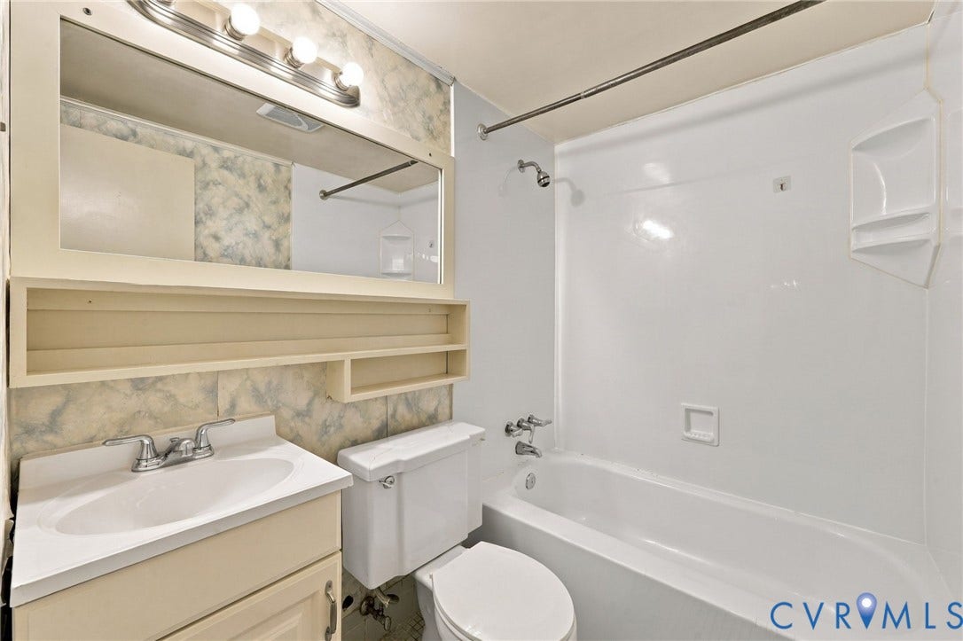 12 Snughaven Road, Hamlet, Henrico, VA 23228 White bathtub and shower combination with integrated shelving