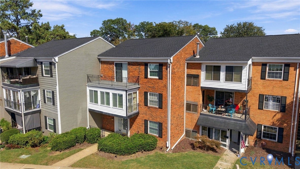 12 Snughaven Road, Hamlet, Henrico, VA 23228 Brick exterior with dark shingle roofing, featuring multiple balconies and bay windows