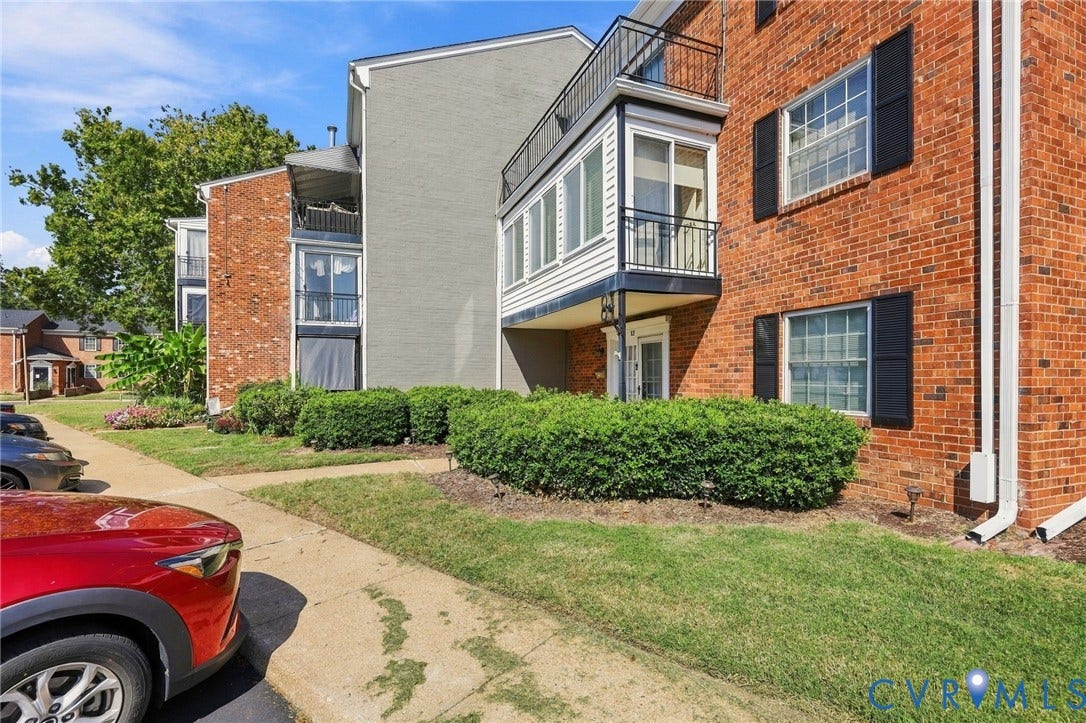 12 Snughaven Road, Hamlet, Henrico, VA 23228 Brick exterior with black shutters and contrasting gray siding