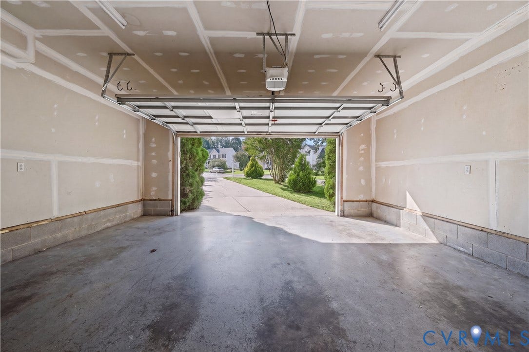 15724 Winding Ash Drive, Chesterfield, VA 23832 Spacious garage with concrete flooring, automatic garage door opener, and block wall foundation