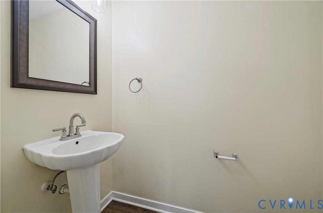 15724 Winding Ash Drive, Chesterfield, VA 23832 Pedestal sink with brushed nickel faucet, framed wall mirror, and neutral wall paint