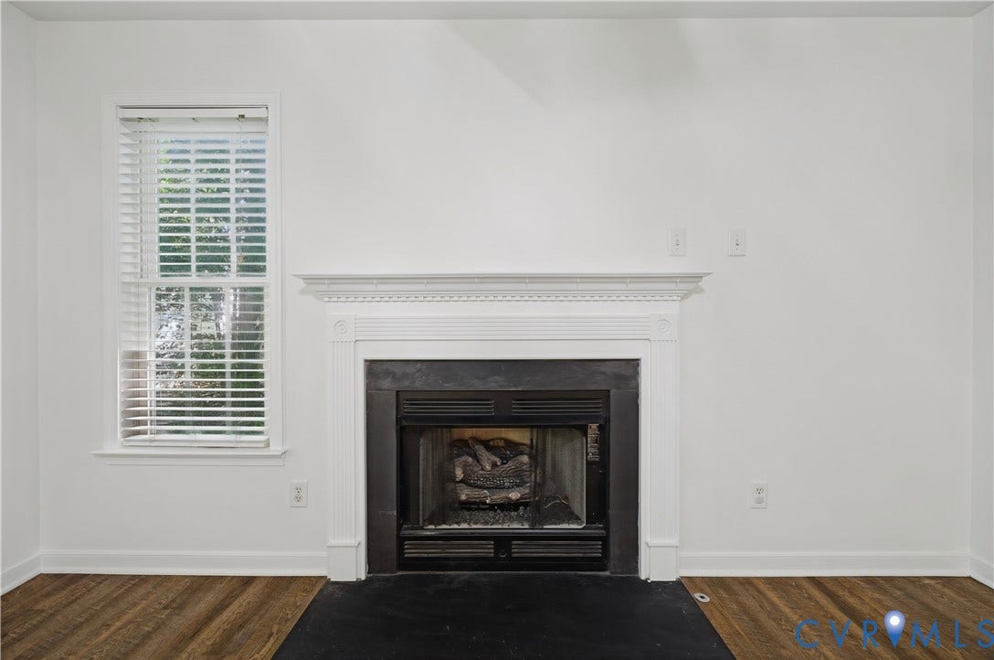 15724 Winding Ash Drive, Chesterfield, VA 23832 Fireplace with a decorative mantel, wood-finish flooring, and a single window with blinds
