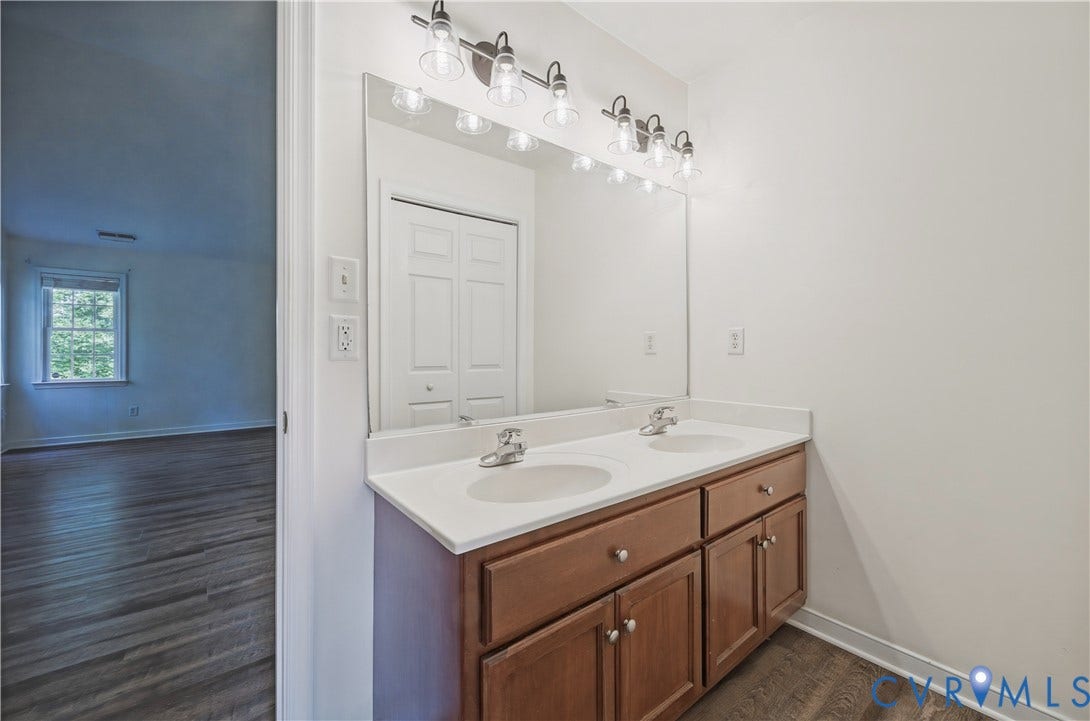 15724 Winding Ash Drive, Chesterfield, VA 23832 Double vanity with wood-finish cabinetry, dual undermount sinks, and a single large mirror