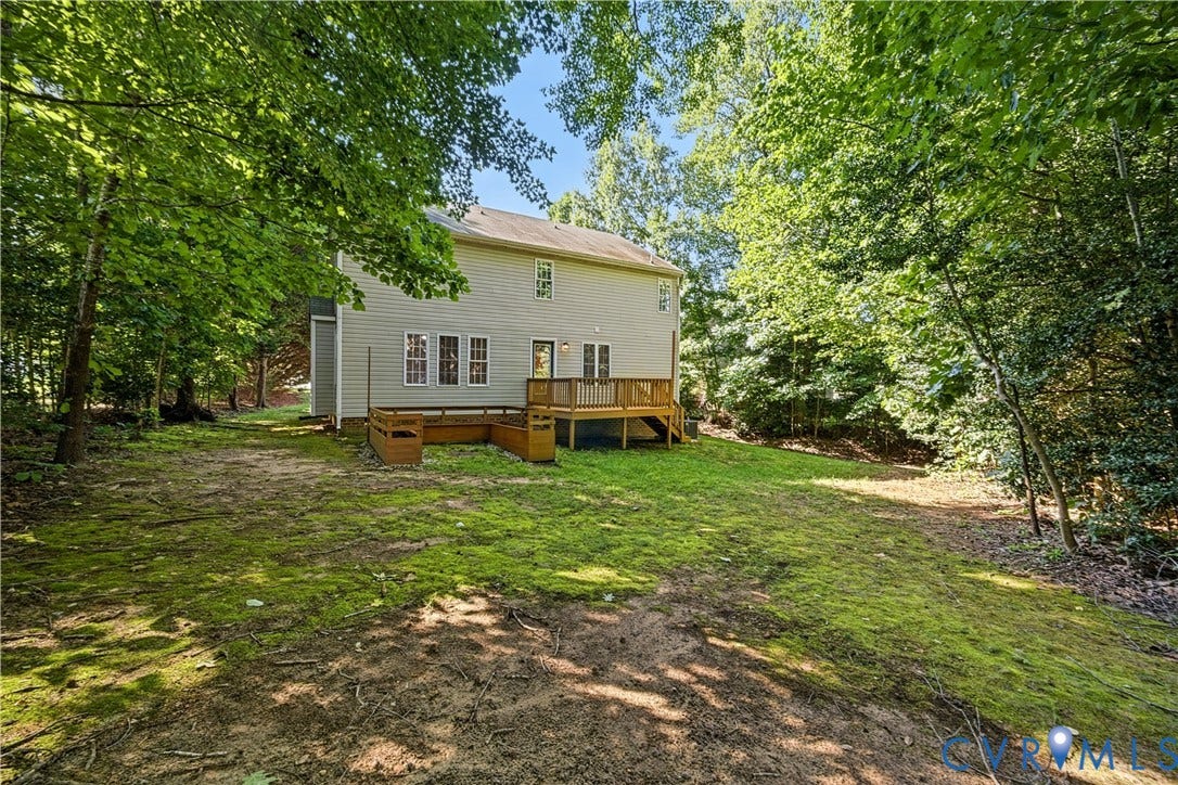 15724 Winding Ash Drive, Chesterfield, VA 23832 Rear exterior with wood-finish siding, a multi-level wood deck, and built-in planters