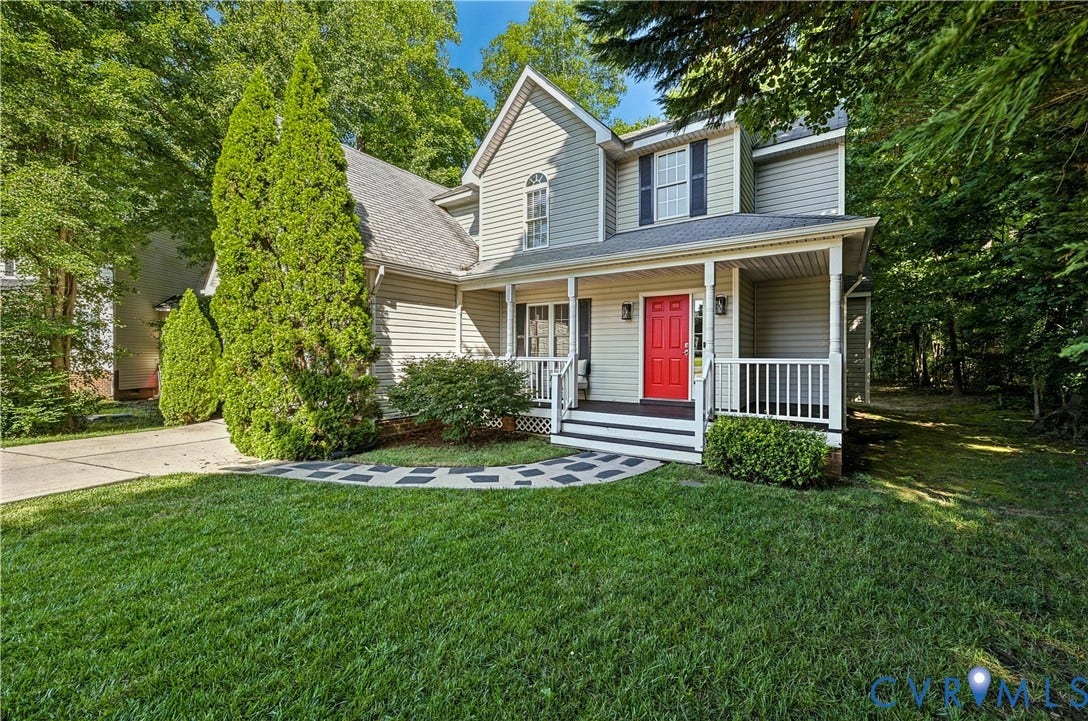 15724 Winding Ash Drive, Chesterfield, VA 23832 Two-story residence with siding exterior, covered front porch, and a vibrant red entry door