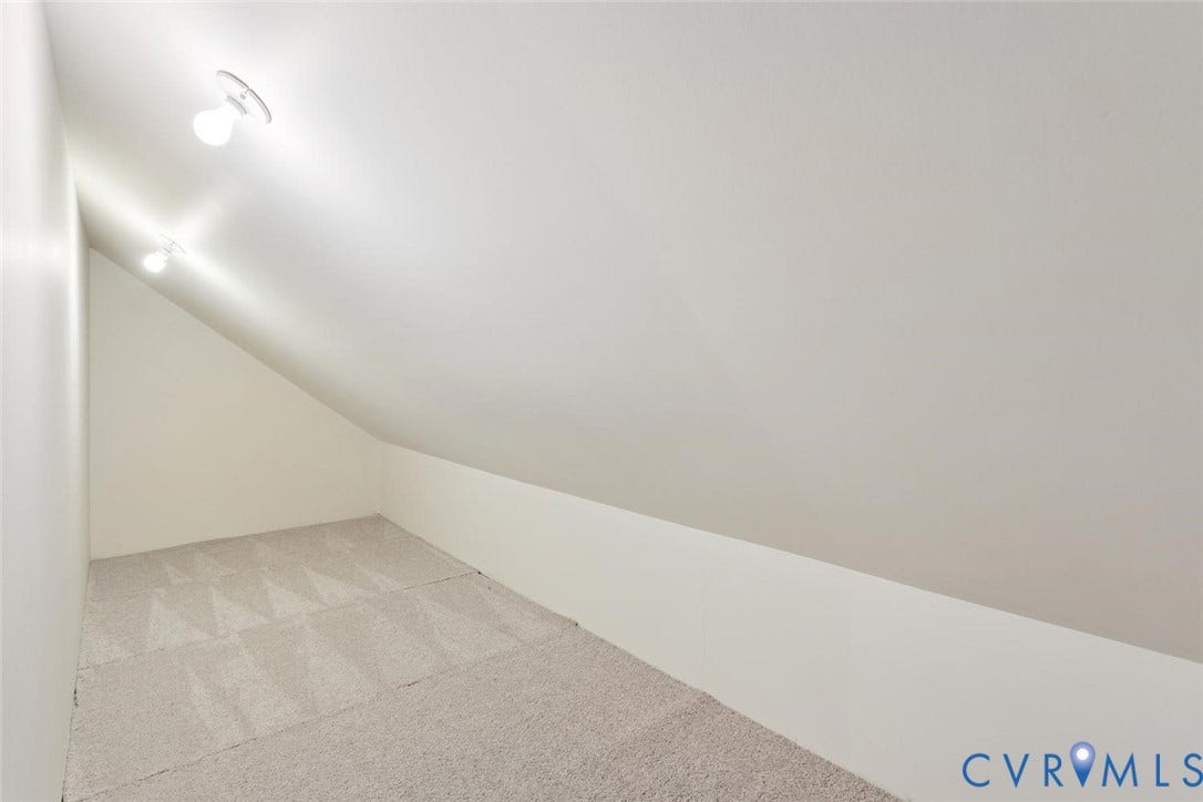 Sloped ceiling room featuring recessed lighting and wall-to-wall carpeting