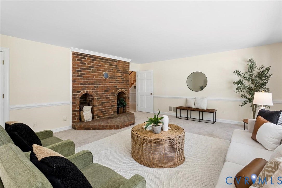 Brick fireplace with two arched niches and a hearth, wall-to-wall carpeting, and neutral wall tones
